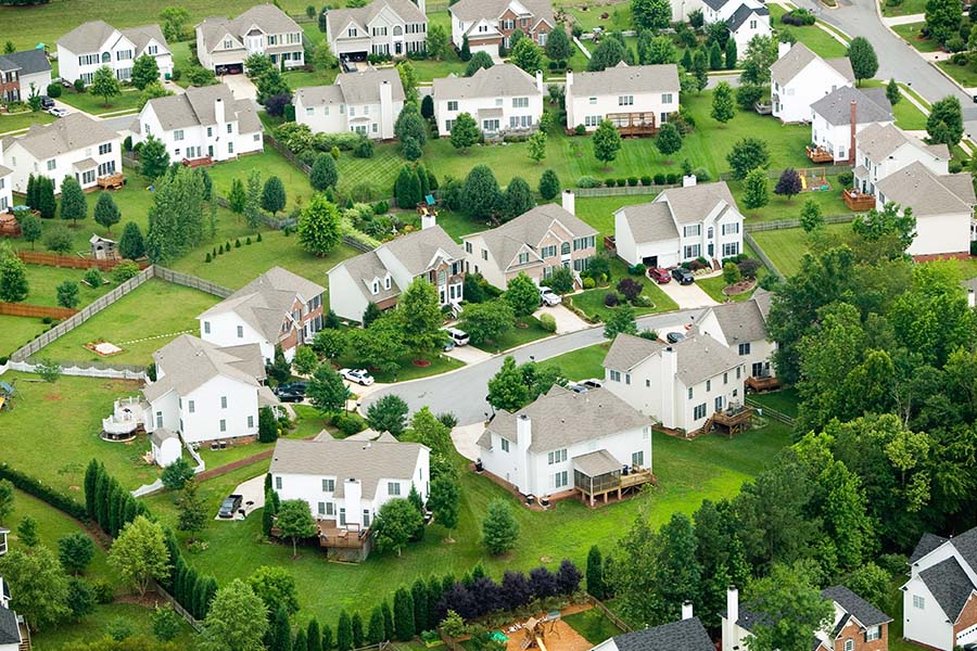 Louisville, KY - Aerial View of Many Residential Homes With Trees and Bushes Around Them on a Sunny Day