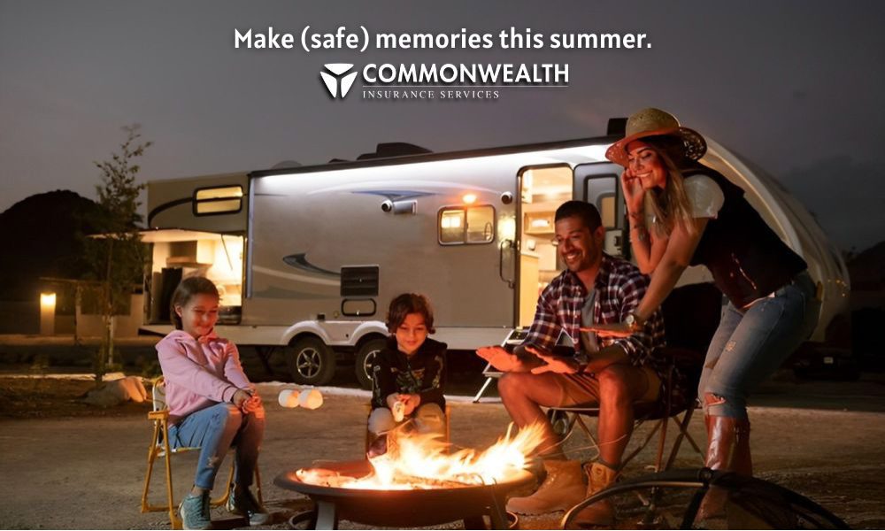 Blog - Family Sitting Around a Fire in the Evening with RV in the Background and Roasting Marshmallows